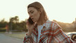 © Fractal Pictures - Disappointed young woman talking on the phone standing in the street at road accident. Mixed-up girl in shirt asking for help calling for the police. Car crash.