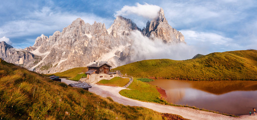Aufkleber - Wonderful Sunny Scenery of Dolomites mountains. Baita Segantini mountain refuge with Cimon della Pala peak during sunset. Amazing Nature Landscape. Rolle pass, Trentino province, Italy, Europe