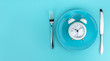 © iloli - Alarm clock with fork and knife on the table. Time to eat, Breakfast, Lunch Time and Dinner concept