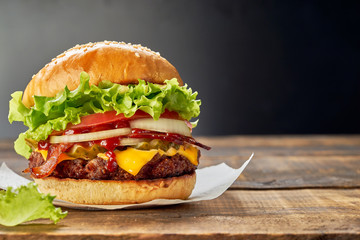 Wall Mural - Juicy hamburger on dark wooden table