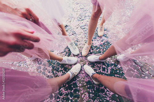Cuadros en Lienzo Stylish girls wears white sneakers and dresses at girls party