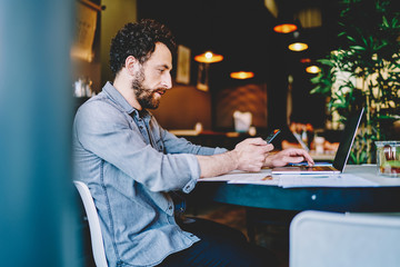 Businessman in casual wear with devices in cafe