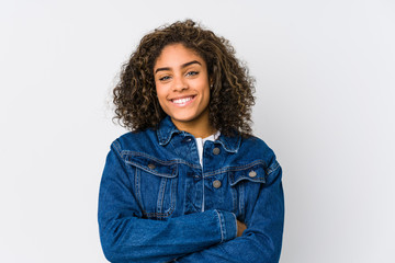 Young african american woman who feels confident, crossing arms with determination.