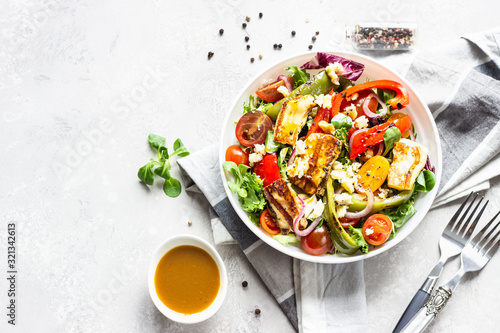 Vegetable salad cherry tomatoes, baked pepper, salad mix and onion with grilled haloumi (halloumi) cheese Poster Mural XXL