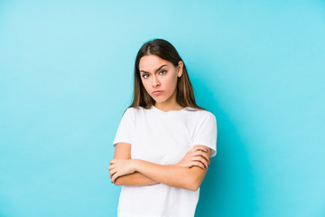 Wall Mural - Young caucasian woman  isolated unhappy looking in camera with sarcastic expression.