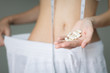 © globalmoments - Diet pills. A woman successful with weight loss. Beauty and health.