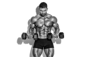 Handsome Bodybuilder Lifting Weights.  Performing Biceps Curls