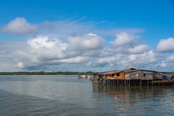 Wall Mural - Port of transport of people with houses mounted on winged wooden piles of the transit bridge. Buenaventura Colombia.