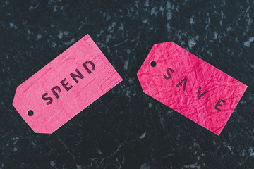 Spend vs Save texts on price tags, budgeting concept