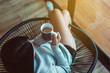 © gballgiggs - Happy woman sitting on chair and drinking hot coffee in bedroom