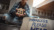 Young homeless boy holding a cardboard house
