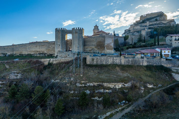 Sunset view of the Porta de Sant Miquel medieval gate protected by two octagonal towers with crenelation, murder hole, portcullis in Morella Castellon Spain 