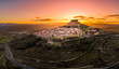 Aerial sunset view of Morella castle and town in central Spain with surrounding medieval walls, towers and winter festival