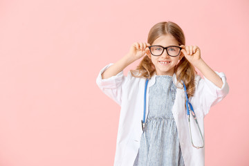 Canvas Print - Cute little doctor on color background