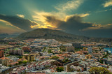 Fototapeta Niebo -  Golden sunrise from behind a mountain and city under a mountain.