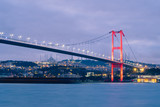 Fototapeta Sypialnia -  Dusk over the First Bosporus Bridge Crossing the Bosphorus or Bosporus Straits Istanbul Turkey. Büyük Çamlıca Camii Mosque and Beylerbeyi  Palace are visible .