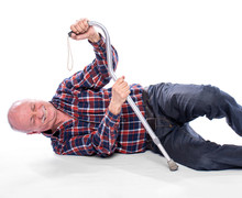  Senior Man Fell To The Floor And Cannot Stand Up Over The White Background