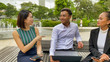 © jovannig - Asian people meeting for business purpose. Young business man and women talking outdoor, front view