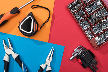 Wall Mural - Top view of tool set with pliers and measuring tape on colorful background