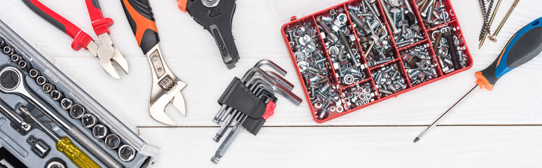 Wall Mural - Top view of tools with tool boxes on white wooden surface, panoramic shot