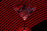 Fototapeta Dmuchawce - Long exposure martini glass with ice and olives