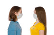 © Andrei - Two teenagers aged 14 and 17 with a protective virus mask on a white background