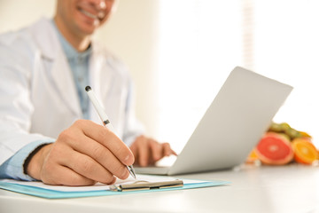 Poster - Nutritionist working at desk in office, closeup