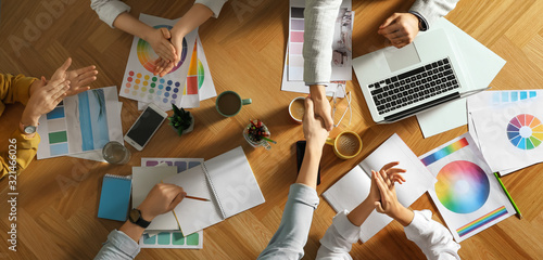 Team of professional designers working together at table, top view Tableau sur Toile