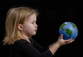 Wall Mural - Little girl holds globe - Planet  Earth symbol. Future Concept