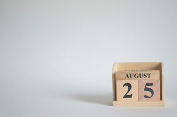 August 25, Empty white background with number cube on the table.