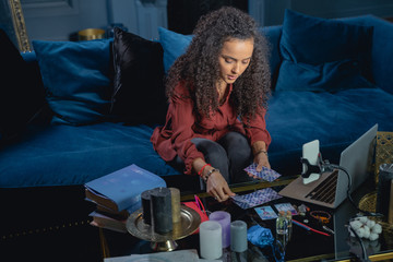 Young female laying out the tarot cards