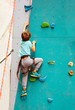 © Sergey Novikov - Little boy on rock climbing on the wall in the sport park