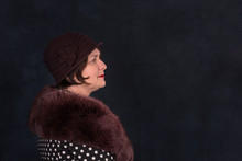 Waist Up Portrait Of   An Elderly Retro Woman Wearing  Fur Cape And Hat Against A Dark Background With Copy Space