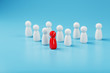 © Alexander - The leader in red leads a group of white employees to victory, HR, Staff recruitment. The concept of leadership.