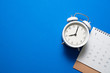 © tatomm - close up of calendar and alarm clock on the blue table background, planning for business meeting or travel planning concept