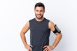 © luismolinero - Young sport handsome man with beard over isolated white background posing with arms at hip and smiling