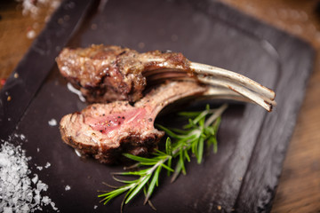 Grilled lamb chops served with a branch of rosemary