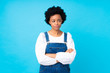 © luismolinero - African american woman with overalls over isolated blue background thinking an idea