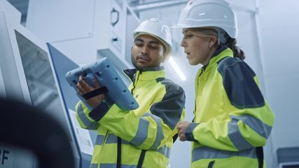 Sticker - Chief Engineer and Project Manager Wearing Safety Vests and Hard Hats, Use Digital Tablet Controller in Modern Factory, Talking, Programming Machine For Productivity. Low Angle Portraits