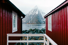 Red Huts And Snowcapped Mountain At The Coast, Hamnoy, Lofoten, Norway