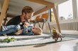 © Westend61 - Father and son playing under table at home