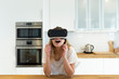 © Westend61 - Female teenager in the kitchen with VR glasses