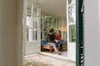 © Westend61 - Happy couple sitting in winter garden, talking, holding hands