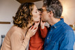 © Westend61 - Couple with daughter kissing at home