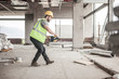 © Westend61 - Construction worker using tape measure in construction site