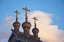 Close Up Old Wooden Domes With Three Crosses Of An Old Russian Church On Blue Sky Background, A Religious Symbol Of Christianity