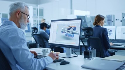 Modern Industrial Factory: Team of Mechanical Engineers Working on Computers, Using Newest High-Tech Devices Like Virtual Reality Headsets to Design Best Engines. 3D Graphics in Contemporary Industry
