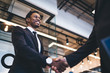 © BullRun - African American man smiling and shaking hands
