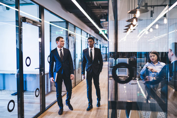 Wall Mural - Diverse colleagues walking in corridors of company office