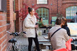 © Anton - Group of friends talking and drinking coffee resting together in cafe outdoor